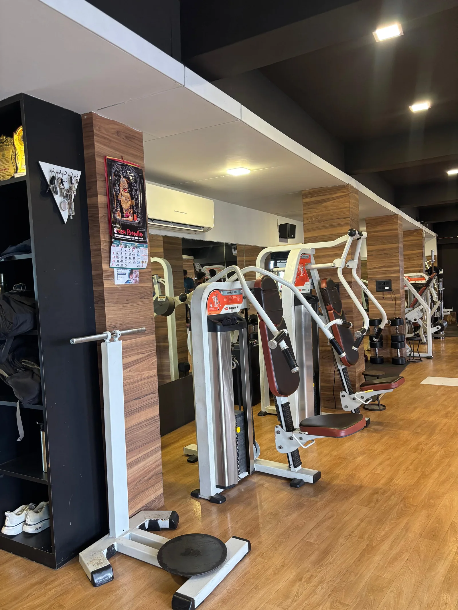 Resistance machines and mirrored wall on the training floor at S R Gym Adajan