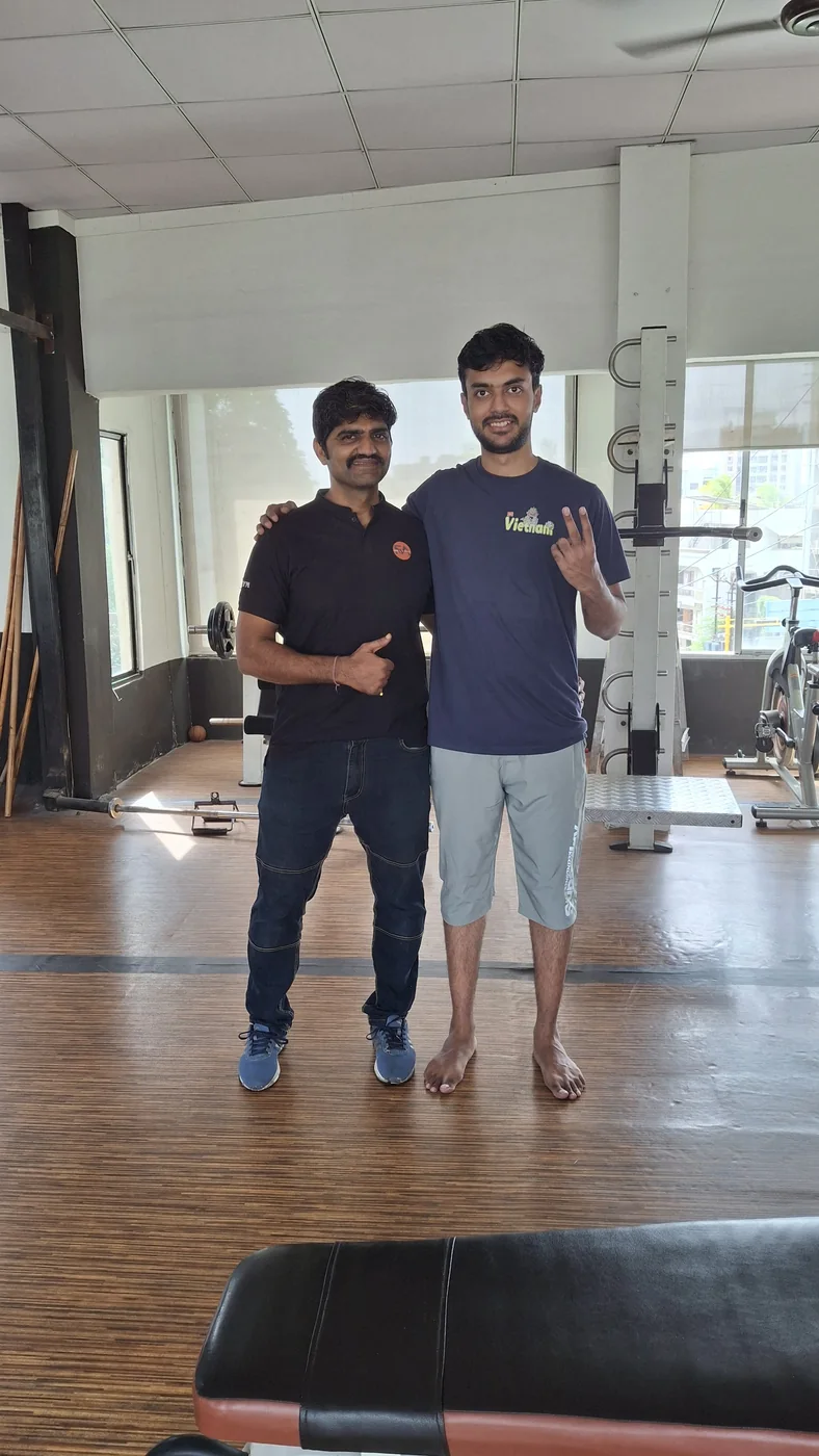 Ashutosh Banerjee with coach Brijesh Joshi on the floor at S R Gym Adajan, Surat
