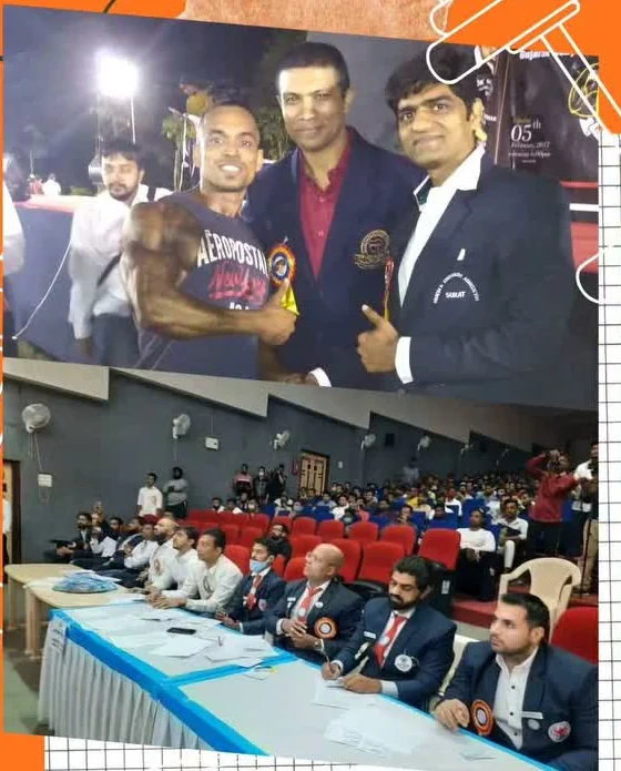 Brijesh Joshi seated on the judging panel at a bodybuilding competition, with competitors and an audience in front of the table